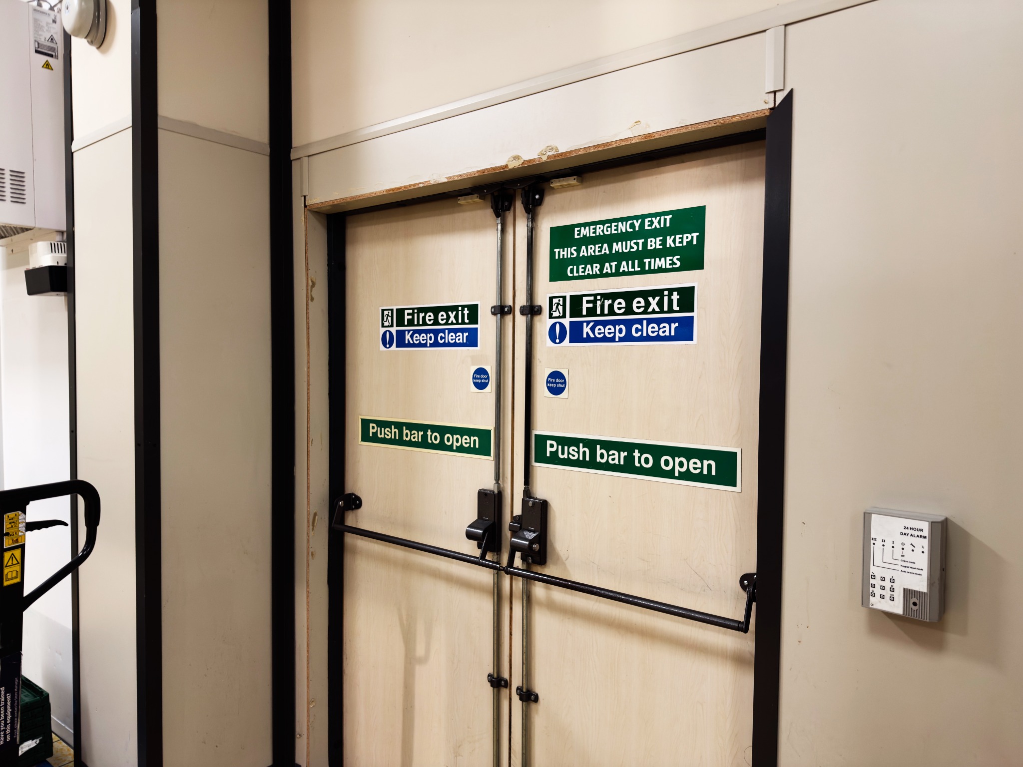 Internal fire exit doors with emergency exit signage and push bars